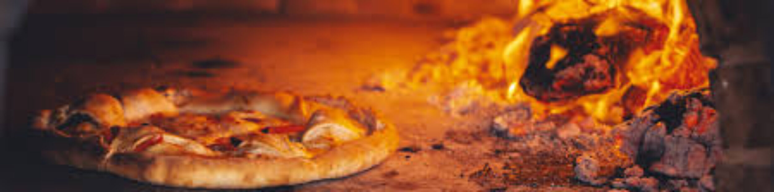pizza cooking in wood fire oven by forno sethi
